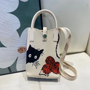 Cream knit phone bag featuring a cute black cat and red flower design for women