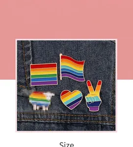 Creative rainbow striped enamel pins set with heart and flag designs on denim