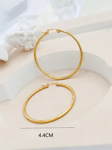 Close-up of gold striped hoop earrings with 4.4cm size annotation in elegant setting