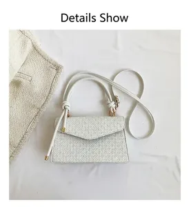 Detailed view of white minimalist retro crossbody bag with textured pattern