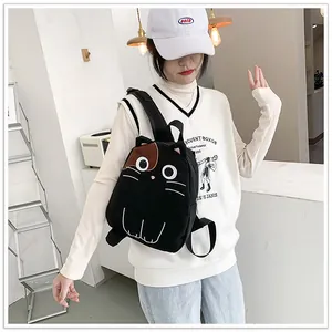 Detailed view of a cute black cat shaped plush backpack worn by a model in Japanese style