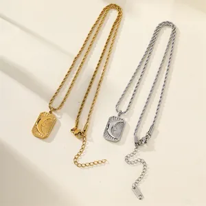 Close-up of vintage sun and moon relief rectangular pendant necklaces in gold and silver.