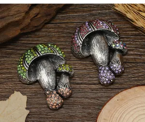 Macro detail of vintage mushroom brooches with colorful rhinestones on a rustic wooden background