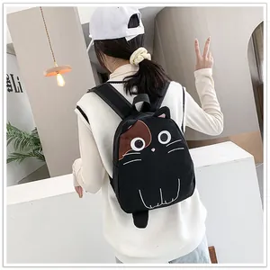 Japanese style cute black cat-shaped backpack with ears worn by a model in a cafe