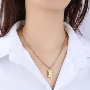 Vintage sun and moon engraved rectangle pendant necklace in gold-plated stainless steel.