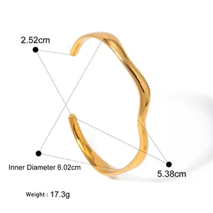 Close-up of gold plated wavy stainless steel cuff showing weight and dimensions