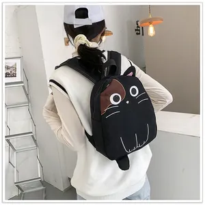 Cute black cat embroidered backpack shown on a girl's back for size reference
