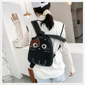 Cute black cat-shaped backpack worn by a model in a stylish modern indoor setting