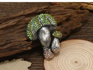 Detailed view of vintage mushroom brooch with shimmering green and brown rhinestones