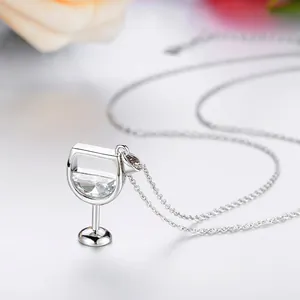 Close-up of silver-tone wine glass pendant necklace with faceted clear zircon stone.