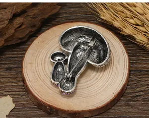 Detailed back view of vintage silver mushroom brooch featuring purple rhinestones