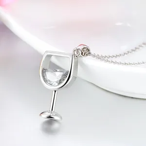 Macro shot of an elegant silver wine glass pendant necklace with sparkling zircon inlay