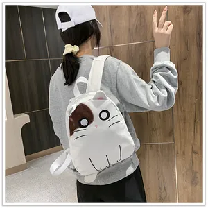 Close-up of a charming white backpack featuring a cute cartoon cat face on a model