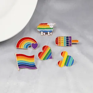 Set of 6 creative rainbow stripe enamel pins in sheep, heart, popsicle and flag shapes.
