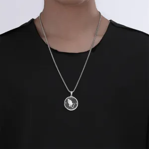 Detailed view of stainless steel praying hands round pendant necklace on black t-shirt