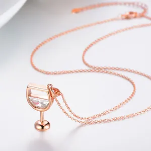 Detail of a rose gold wine glass necklace featuring clear cubic zirconia centerpiece.