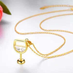 Detailed macro view of a gold-plated wine glass pendant necklace with a sparkling zircon stone