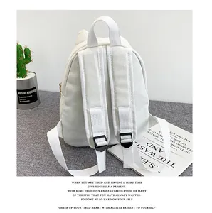 Back view of cute white canvas backpack with cat ear details and adjustable straps
