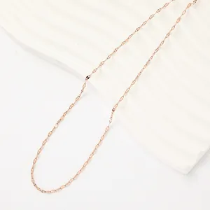 Macro detail of a minimalist rose gold stainless steel lip chain necklace link texture