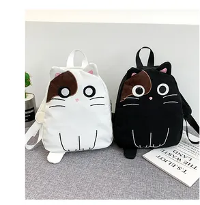 Detailed view of cute cat-shaped canvas backpacks shown in black and white colors