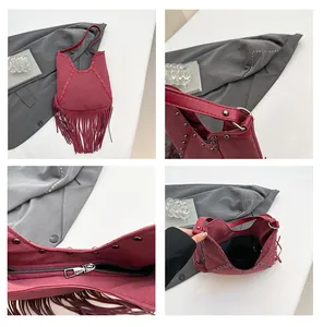 Detailed view of Bohemian wine red tassel bag with studs and interior pocket.