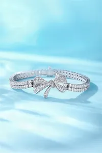 Detailed view of an elegant S925 silver ribbon bow bracelet with sparkling stones