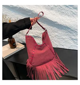 Vintage Bohemian burgundy suede fringe tote bag featuring sun embossing and studs.