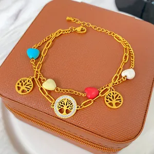 Close-up detail of 18K gold-plated titanium steel double-layer bracelet with charms