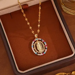 Close-up of vintage Virgin Mary pendant with colorful zircons on a gold chain in box