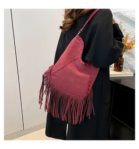 Bohemian retro fringe shoulder bag featuring metal studs and sun embossing detail