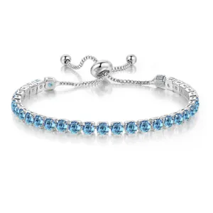 Macro view of light blue round cubic zirconia stones on silver adjustable bracelet