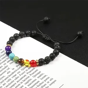 Close-up of natural lava stone beaded bracelet with rainbow chakra accents