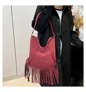 Retro red bohemian tassel hobo bag featuring a sun motif and silver stud accents detail.