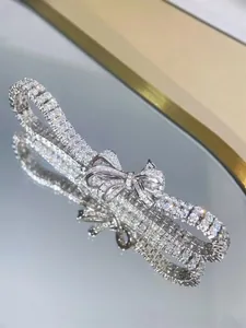 Close-up of silver ribbon bow bracelet with sparkling pavé stones