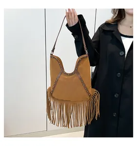 Vintage bohemian brown suede fringe shoulder bag with stud details and long strap.