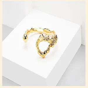 Exaggerated 18K gold plated irregular open bangle with unique knotted design detail