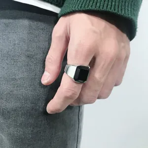 Close-up of men's vintage silver ring with square black stone inlay