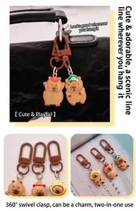 Detailed macro shot of cute resin capybara keychains with 360-degree rotating metal hooks