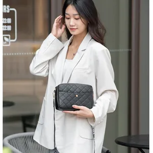 Stylish black quilted crossbody bag for women, chic camera bag style with adjustable strap