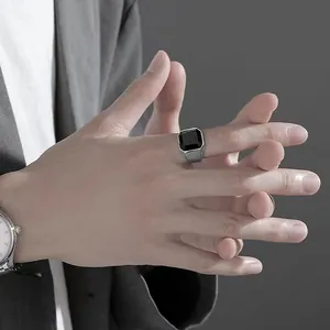 Detailed shot of a men's silver square ring featuring a large black agate gemstone.