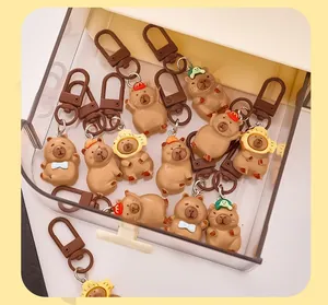 Detailed view of assorted cute resin Capybara keychains in a clear storage box