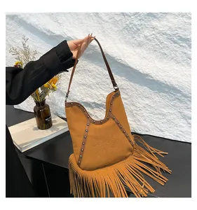 Vintage bohemian brown suede fringe hobo bag with embossed sun and metal stud details
