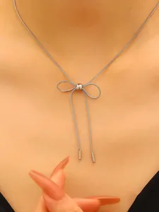 Elegant silver stainless steel bow pendant necklace on snake chain detail view