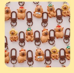 Close-up of cute cartoon Capybara resin keychains with various fun headwear designs