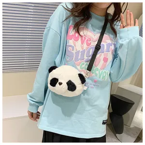 Close-up of a cute plush panda crossbody bag with a fuzzy texture and black strap