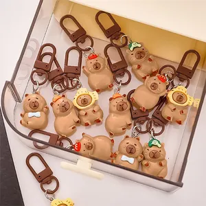 Set of adorable cartoon Capybara resin keychains with various accessories in a storage case.