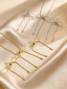Detailed macro view of gold and silver stainless steel bowknot jewelry accessories