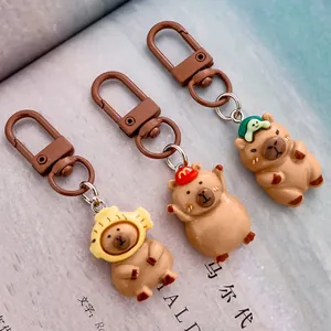 Cute resin capybara keychains featuring funny food hats for bag and backpack decoration