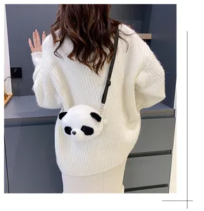 Cute panda shaped plush crossbody bag shown on a model wearing white knit sweater
