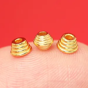 Close-up of S925 gold-plated saucer spacer beads with engraved antique texture